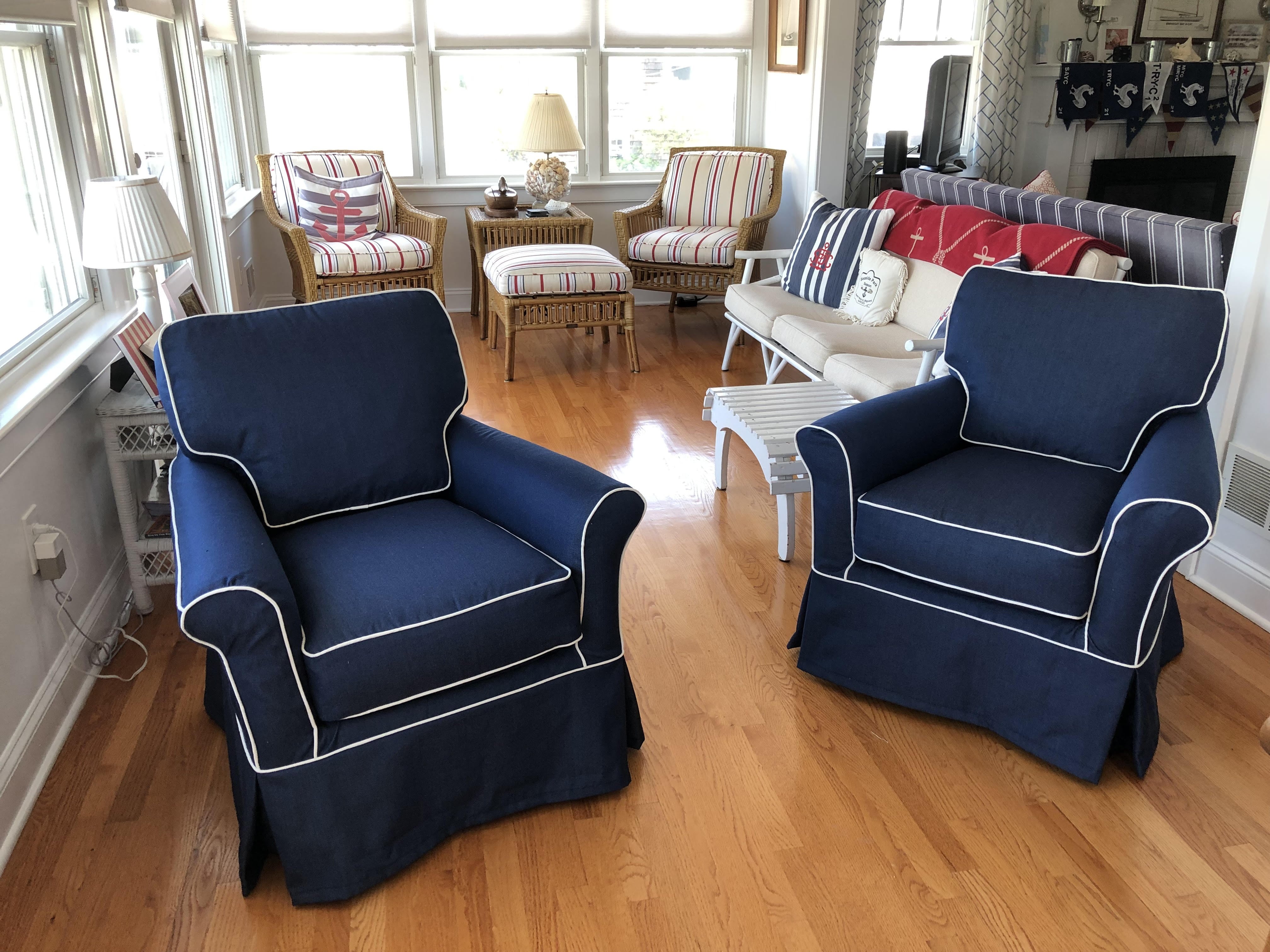 Bayview porch with 2 club chairs slipcovered in navy duck with contrasting white trim in seams