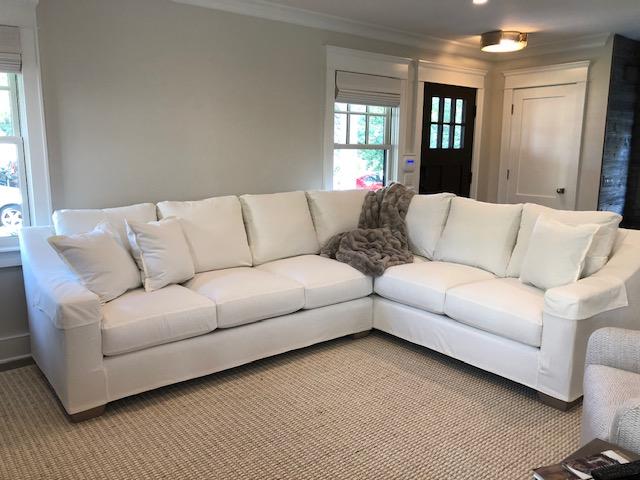 White sectional sofa slipcovered in soft cotton brushed denim.
